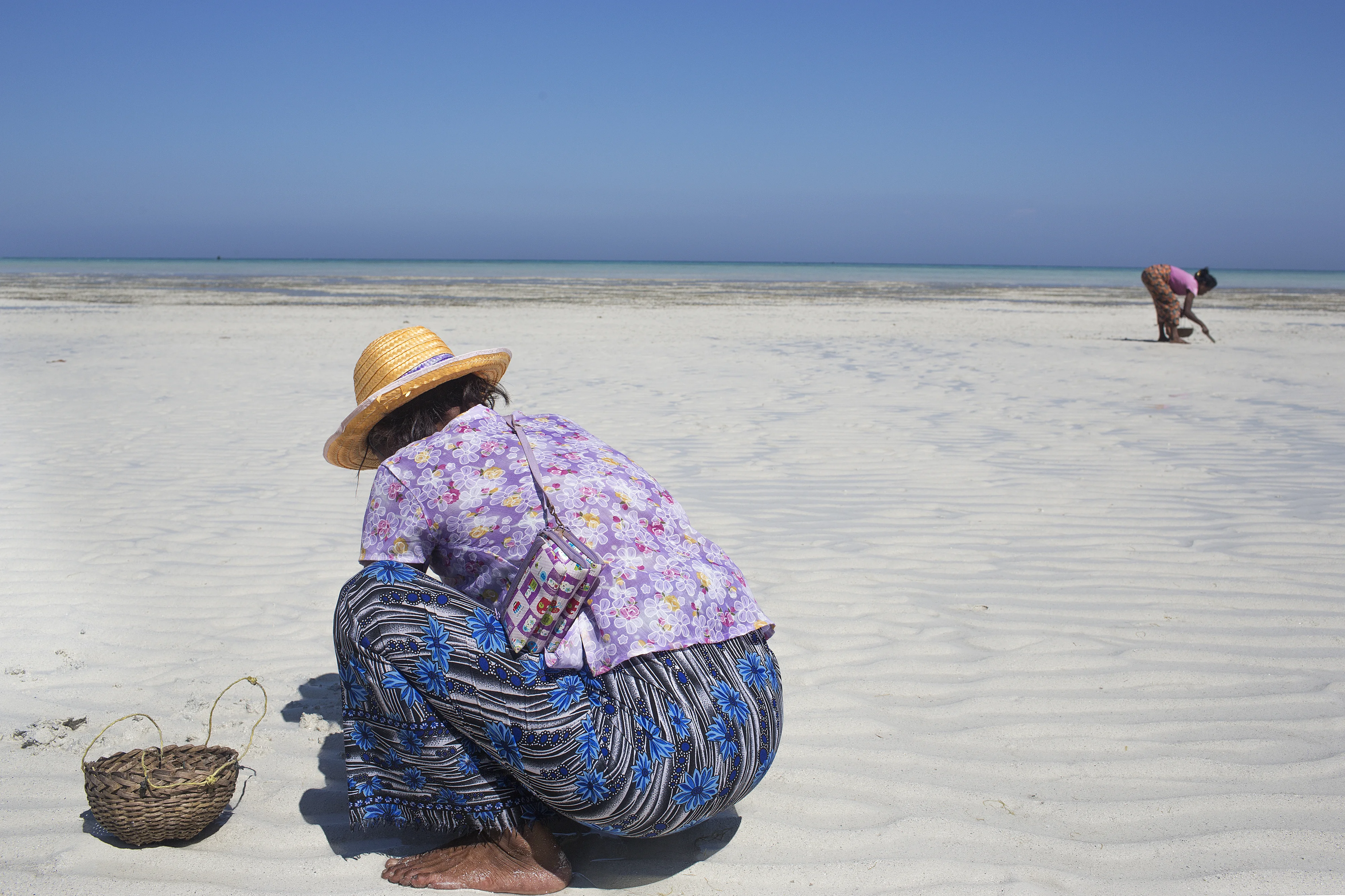 A Moken woman forages for food at low tide in Ko Surin, Thailand. The Moken are a seafaring people who for centuries lived nomadically on the Andaman Sea. Due to stricter border control, commercial overfishing, rapid development, and tourism, the Moken hav